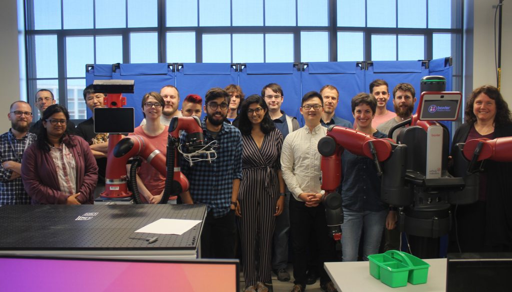 The SUCCESS MURI team posing with Rethink Robotics Sawyer and Baxter robots.